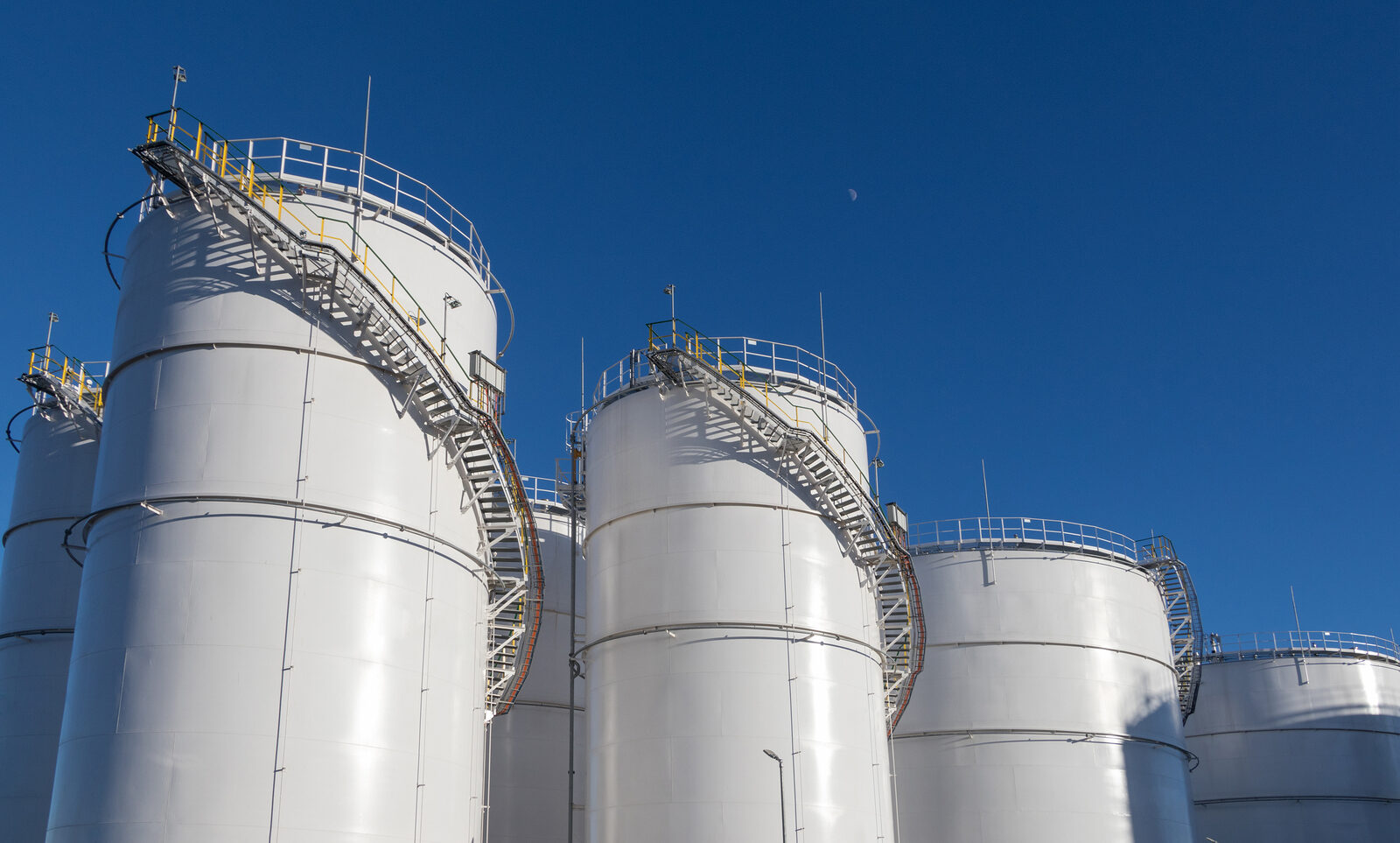 Fuel Tanks At The Tank Farm. Big Industrial Oil Tanks In Petrole